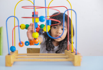 autistic girl concentrating playing with blocks. the girl does not respond to the world around us. Autism Concept