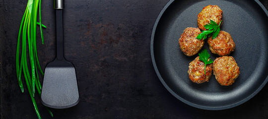 top view on cutlets on pan and spatula on board over old rustic background