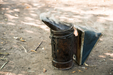 The beekeeping Smoker on the soil