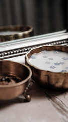 Milk and blue flowers in a bronze bowl.