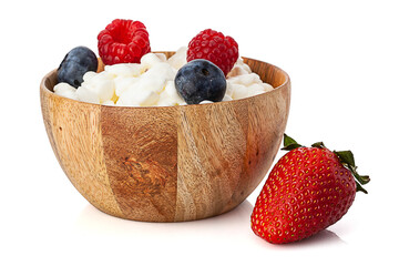 wooden bowl with cottage cheese and berries isolated on white background