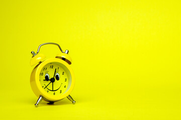 Old clock isolated on a yellow  background with space for text