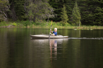 Boy kayaking on Moose Creek Reservoir in northern Idaho
