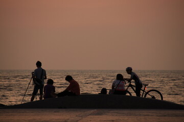 silhouette of a people on the beach at sunrise