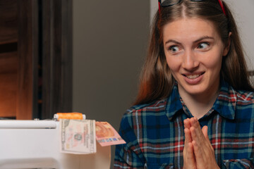 Portrait of a beautiful seamstress designer, with a cunning look at money. Small business opens