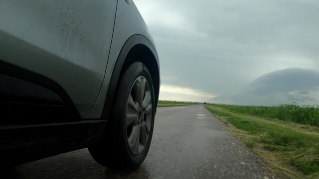 Close up of car wheel and tyre on wet road