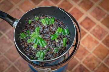 Southeast Asia, Thailand fried crickets are cooked by oil in the pan with outdoor portable picnic gas stoveat.