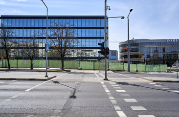 Fototapeta na wymiar Street with pedestrian crossing and new unfinished office building in the background