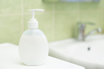 White bottle with aromatic liquid soap in the bathroom