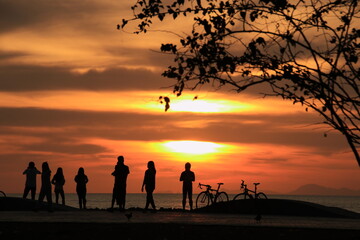 silhouette of a people on the beach at sunrise