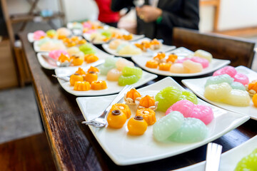 Traditional Golden and colorful Thai Dessert; JaMongKut, SaNayChan, ThongAek, MedKaNoon and Woon are set in seperated square white dish for serve to meeting member.