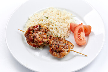 pork kebab with rice on the white plate