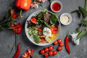 fresh healthy light breakfast, business lunch. Breakfast with poached egg, buckwheat, red fish, fresh salad, cucumbers and cherry tomatoes, business lunch concept