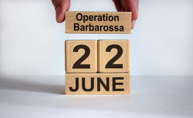 Male hand puts a block with the inscription 'operation barbarossa' on cubes with the date June...