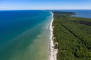 Beautiful view from above of the Curonian spit national Park. On the right - the blue Baltic sea, on the left-the Curonian lagoon. A sandy strip of beach stretches away into the distance.