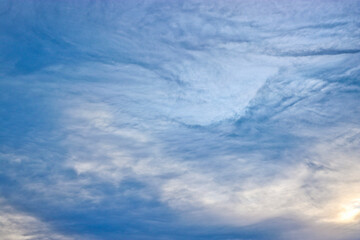 Evening sky with cirrus clouds. Natural background. The texture of the clouds.