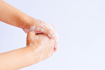 Child washing hands with soap on white background, concept of hygiene and health care