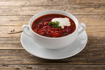 Traditional Ukrainian Russian borsch. Beetroot soup on wooden table 