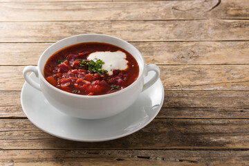 Traditional Ukrainian Russian borsch. Beetroot soup on wooden table copy space