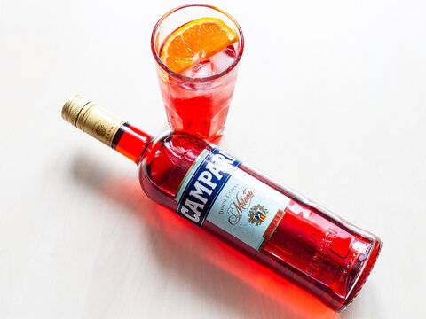 MOSCOW, RUSSIA - JUNE 4, 2020: top view of lying bottle of Campari bitter and glass with cocktail on table. Campari is italian alcoholic liqueur belong to Davide Campari Milano S.P.A. Gruppo Campari