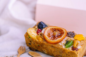 Fresh homemade fruit cake with juicy candied fruits topping