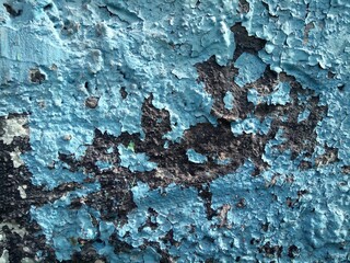 old peeling blue paint on concrete wall