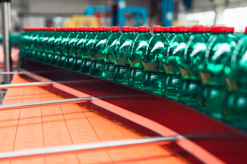 Bottling plant - Water bottling line for processing and bottling carbonated water into green bottles. Selective focus.