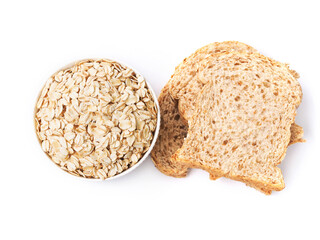 Top view of rolled oat flakes whole grain in bowl and whole wheat bread isolated on white background.