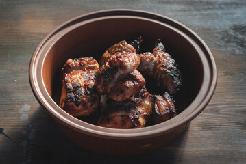 Pork barbecue in a plate on the old table background.