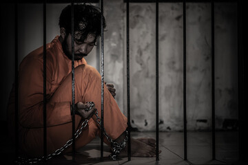 Asian man desperate at the iron prison,prisoner concept,thailand people,Hope to be free,Serious...