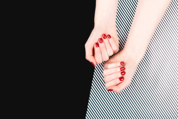 Woman hands with perfect classic manicure with red polish. Minimal black and white background. Copy space for your text.