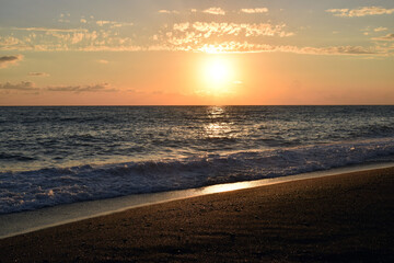 Naklejka na ściany i meble Sunset over the sea. Beach