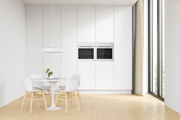 Side view of the white interior of the kitchen and dining room with wooden floors, a white suite, a table and chairs and a large window. 3d rendering.