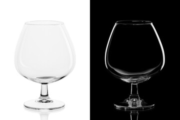 Empty cognac glass isolated on black and white background