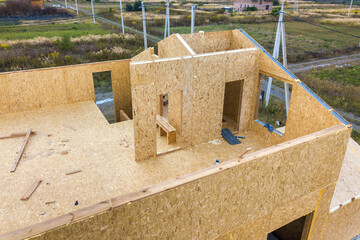 Construction of new and modern modular house. Walls made from composite wooden sip panels with styrofoam insulation inside. Building new frame of energy efficient home concept.
