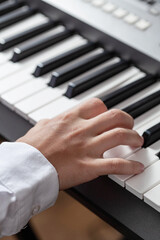 Closeup hand man playing piano.