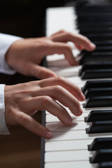Obraz premium Closeup hands man playing piano. music instrument.