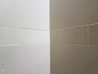 grey tiles in a corner of a bathroom