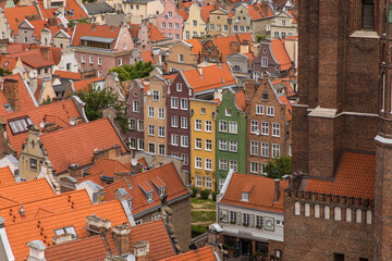 Fototapeta na wymiar Gdansk, Poland - Juny, 2019: Red roofs, old buildings and colorful houses in Old Town Stare Miasto in Gdansk, aerial view from cathedral St. Mary's Church tower, Poland