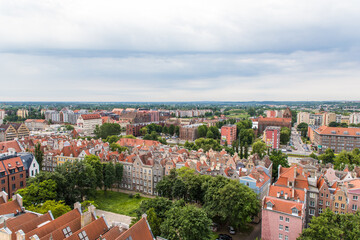 Gdansk, Poland - Juny, 2019: Red roofs, old buildings and colorful houses in Old Town Stare Miasto in Gdansk, aerial view from cathedral St. Mary's Church tower, Poland