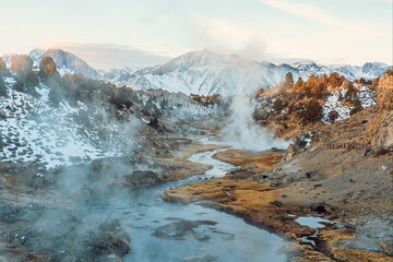 Deer crossing winding river with mountains in background
