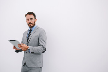 Serious male CEO is reading resume specialists before interview