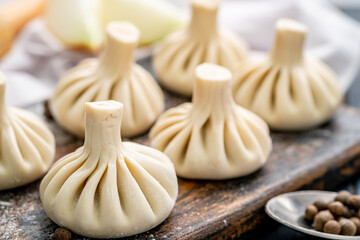 Raw baozi dumplings on wooden board