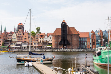 Fototapeta premium Gdansk, Poland - Juny, 2019. Gdansk old town and famous crane, Polish Zuraw. View from Motlawa river. The city also known as Danzig and the city of amber.