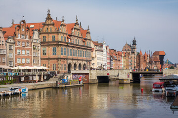 Naklejka na ściany i meble Gdansk, Poland - Juny, 2019:. Beautiful multi-colored houses in the old town in Gdansk. The central streets of the historic center of Gdansk. The main tourist attraction of Gdansk.
