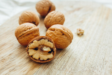 Unpeeled walnuts on wooden surface, closeup.  Food photo. Selective focus.