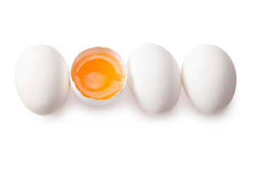 Chicken egg is half broken among other eggs isolated on white background. Top view