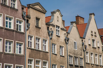 Fototapeta na wymiar Gdansk, Poland - Juny, 2019:. Beautiful multi-colored houses in the old town in Gdansk. The central streets of the historic center of Gdansk. The main tourist attraction of Gdansk.