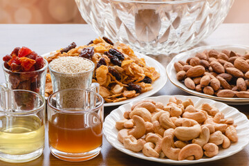 Mixture of making homemade cereal cookies on wooden table,Is an easy-to-make food for health lovers,Cashew,Almonds,Corn cereal,raisin,Dried Strawberries,White sesame ,honey,egg white, Selective focus.