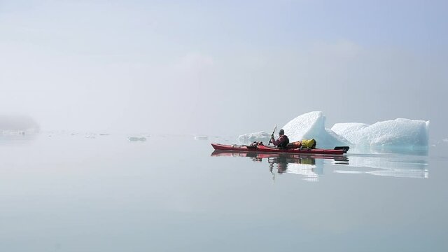 WS TS Woman kayaking in fjord / Narsaq, South Greenland, Greenland
